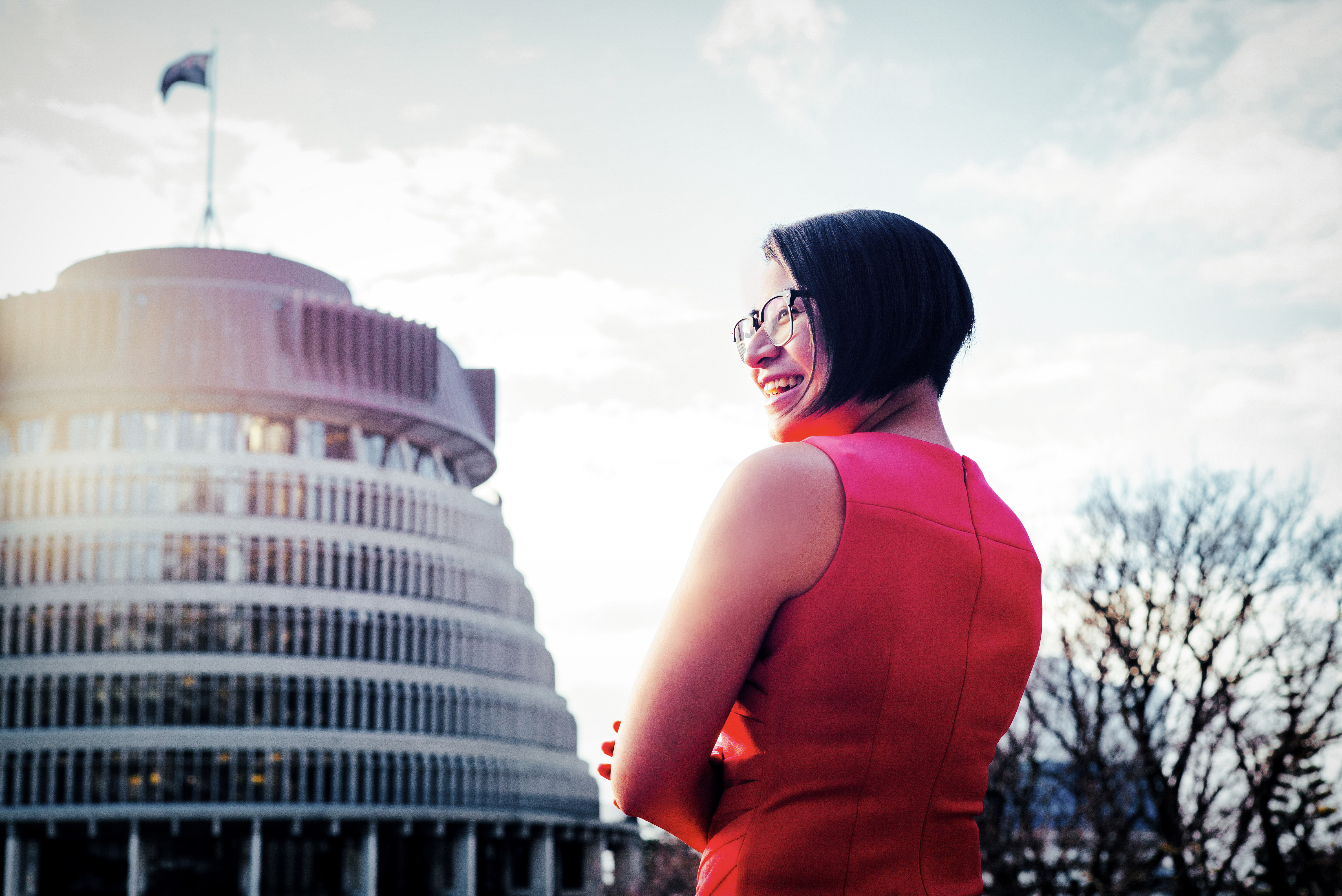 A woman in a red dress standing in front of the Beehive