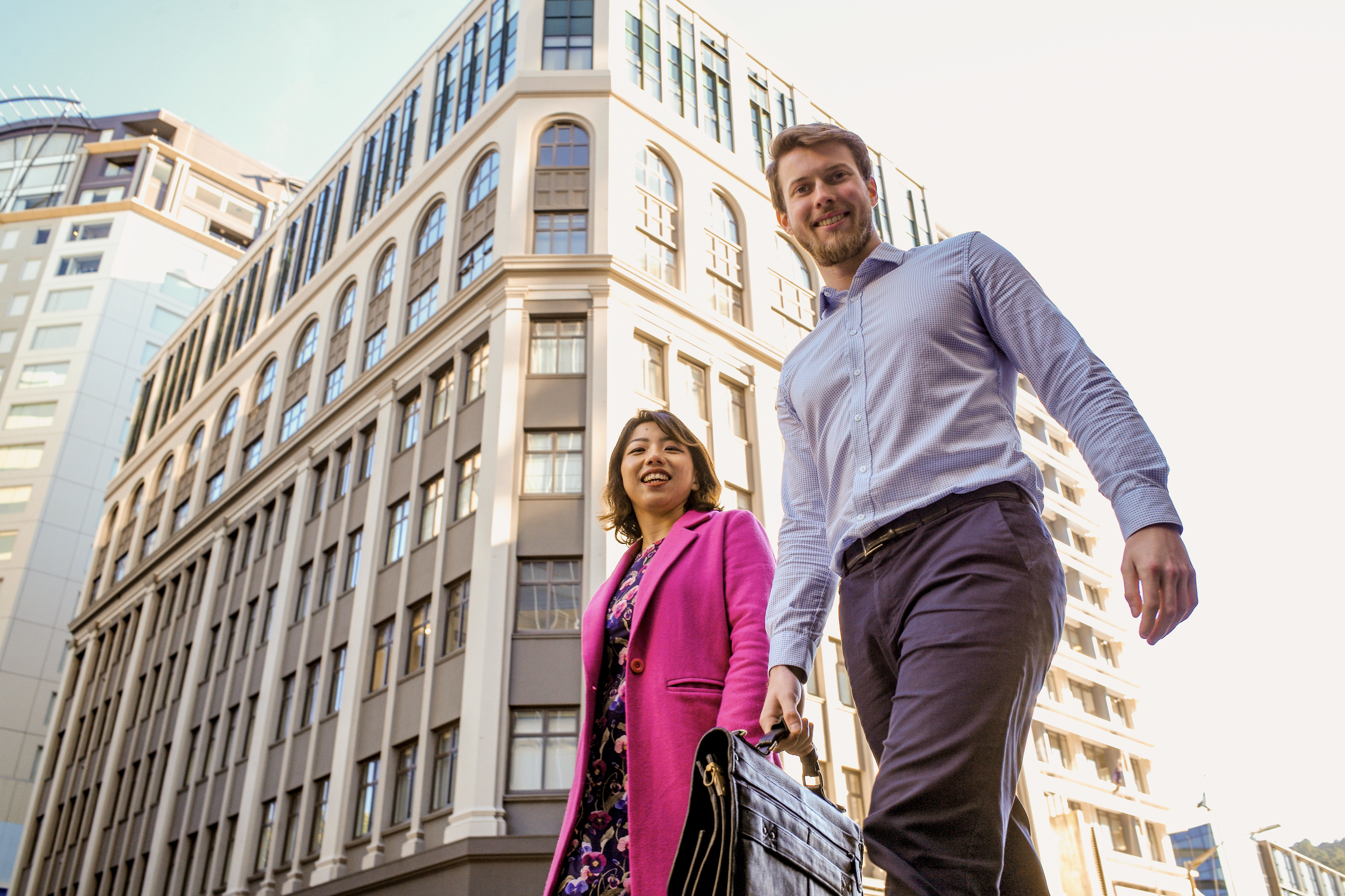  A man and woman stroll together down a city street