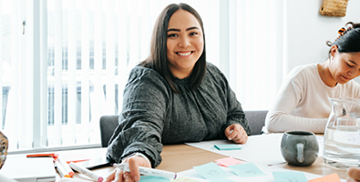 Female smiling sitting at a desk