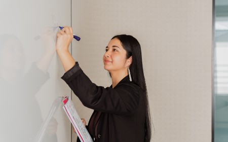 Woman writing on a whiteboard