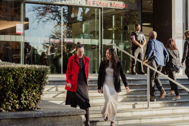 People walking down the stairs of the RBNZ building