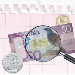 A close-up of a $50 note with a magnifying glass over it