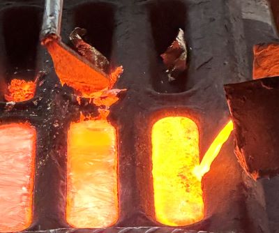 Smelted-down coins are made into aluminium-bronze bars