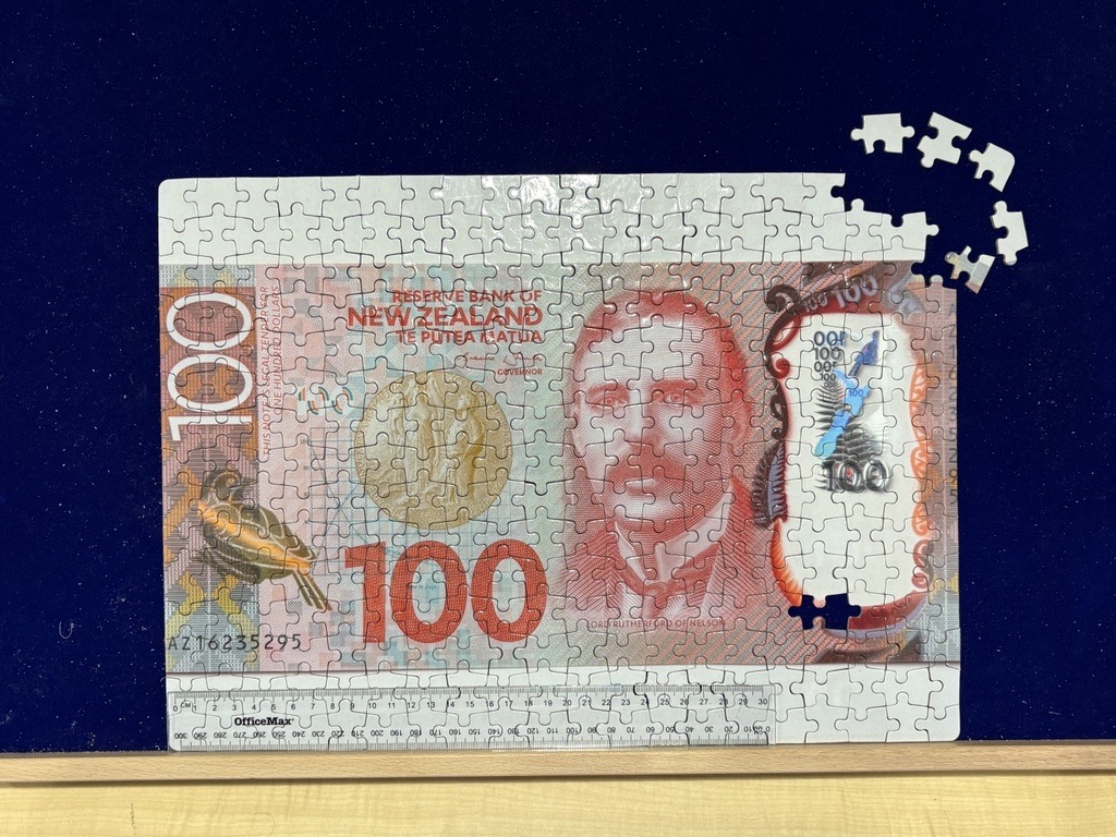 A jigsaw puzzle of a New Zealand $100 banknote