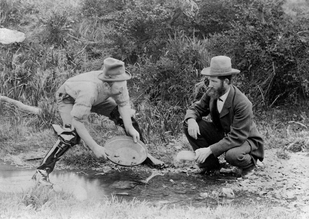 Photograph of two men panning for gold