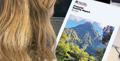 RBNZ team member reading the May 2024 FSR.